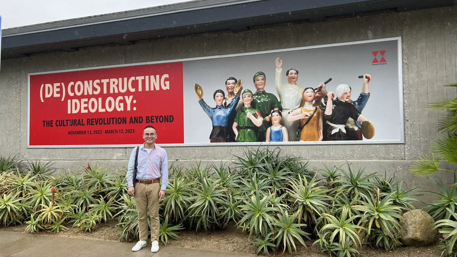 Yifan Li by exhibition sign