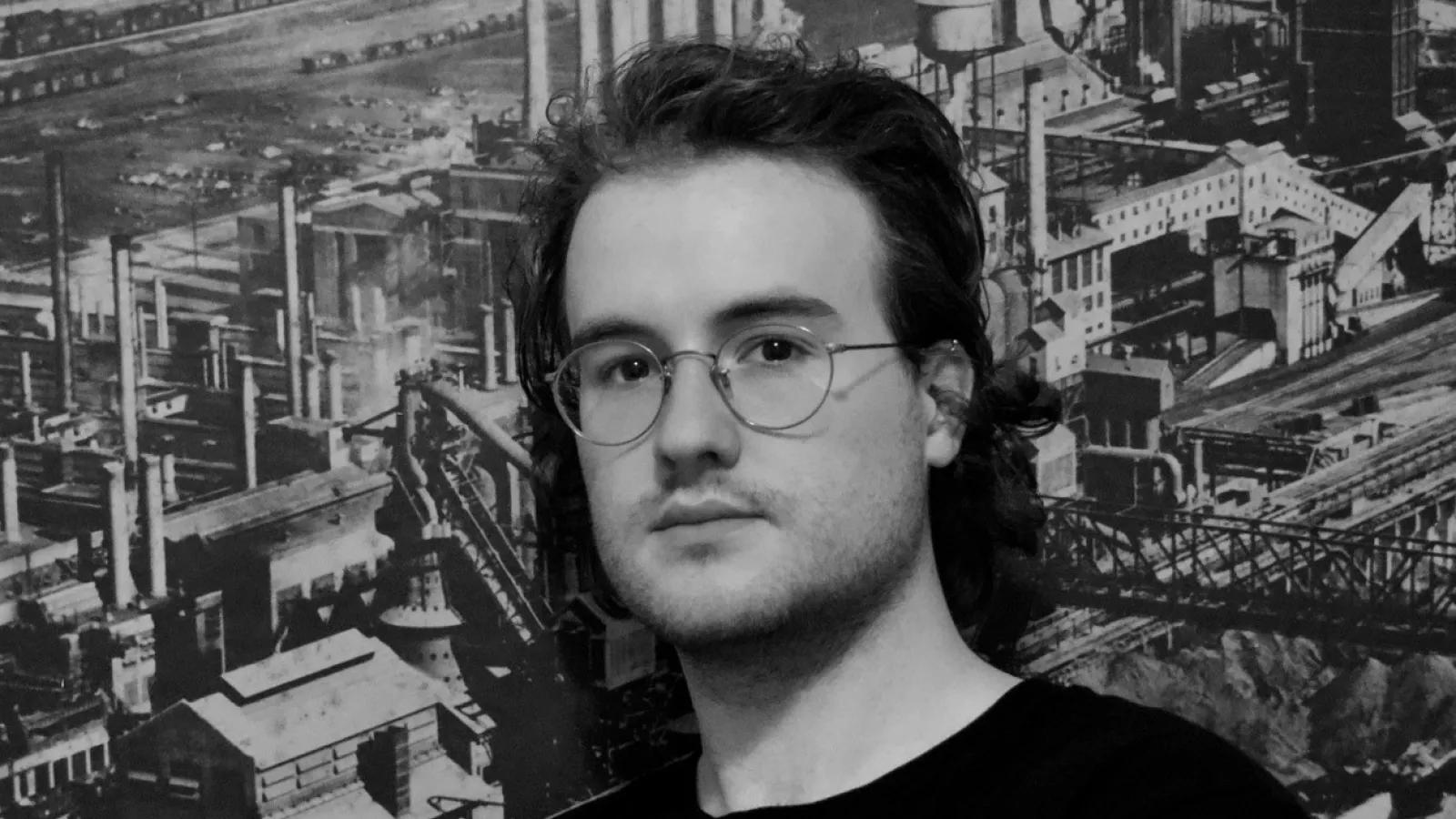 schuyler headshot against black and white photographic background