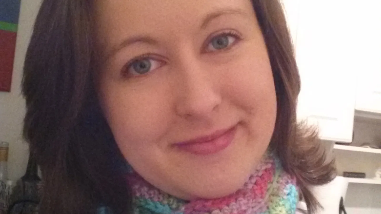  Rebecca Howard wearing a pink top and rainbow scarf