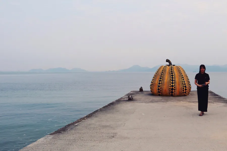 Alice Phan with Yayoi Kusama pumpkin sculpture