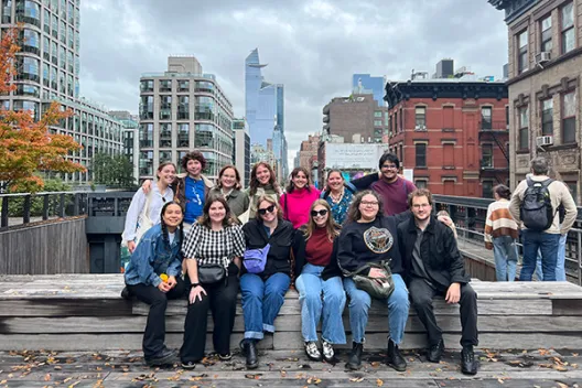 History of Art majors pose together in front of an urban landscape in New York