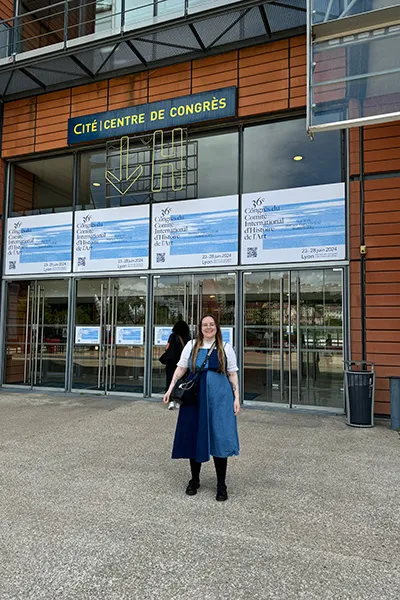 Graduate student April Riddle stands in front of the Centre de Congrès de Lyon