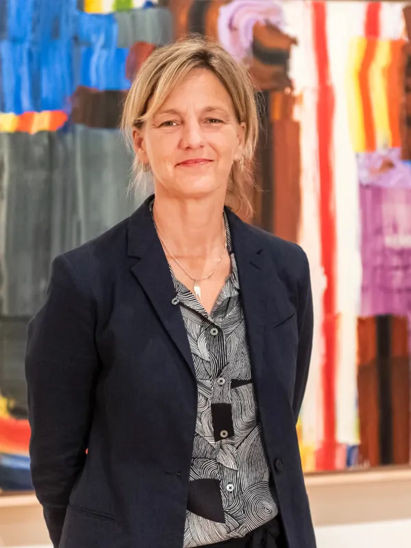 jody patterson standing in front of lichtenstein painting