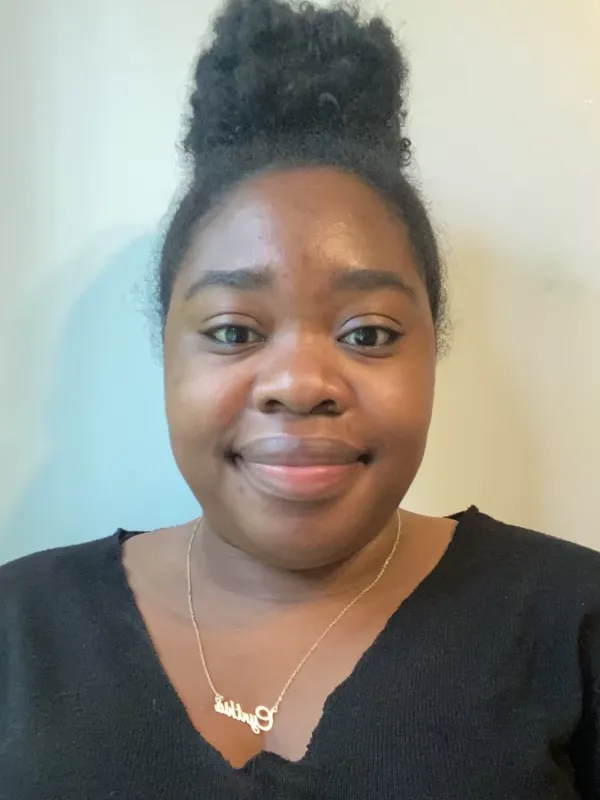 Cynthia Hodge-Thorne wearing a black top behind a white wall